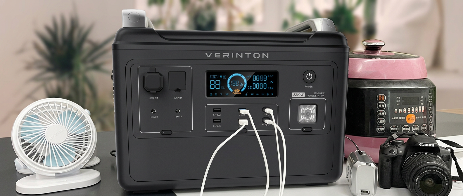 VERINTON Apex 2400 Pro on a desk charging a fan, a camera, phones and a multicooker at the same time